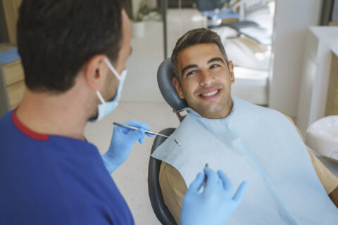 Young man gets consultation for dental implant from dentist at Atlanta Oral Surgery,GA