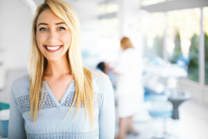 A woman wearing a blue top smiling in Atlanta, GA 