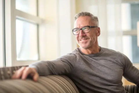 Man sitting on a sofa smiling